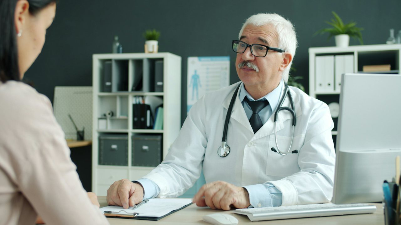 A doctor in conversation with a patient during a consultation